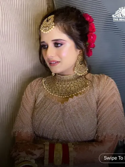 A side profile of this stunning engagement or reception look. The golden glittery eyeshadow and floral bun create a look that is both glamorous and romantic.