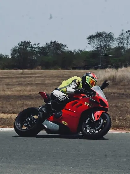 A rider on a Ducati Panigale demonstrates the proper technique for navigating a corner at speed, a key focus in our advanced riding courses.