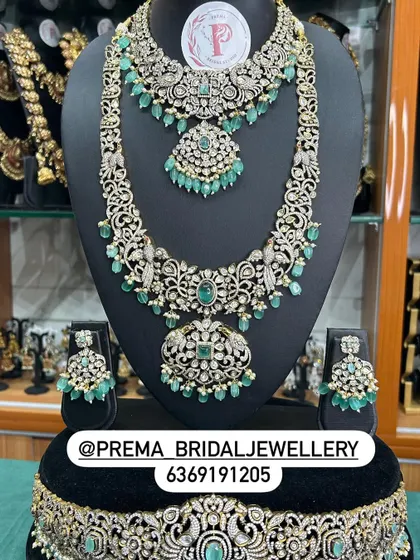A stunning AD and emerald set with peacock motifs.