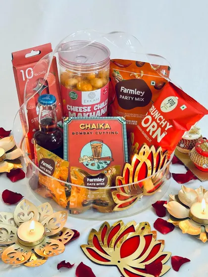The combination of red and gold in this hamper, from the lotus decor to the snacks, creates a traditionally festive look.