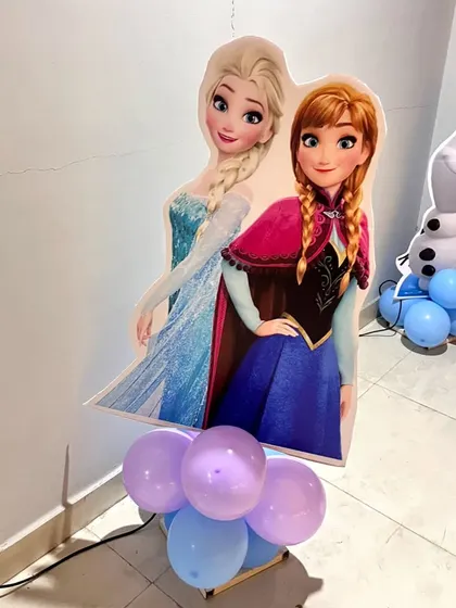 A life-sized cutout of Anna and Elsa from Frozen, perfect for photos at a themed birthday party.