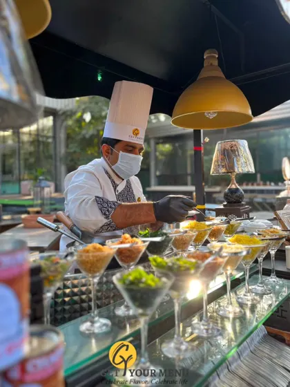 A chef meticulously prepares customized soup servings in martini glasses at our elegant Ouve Soup Counter.