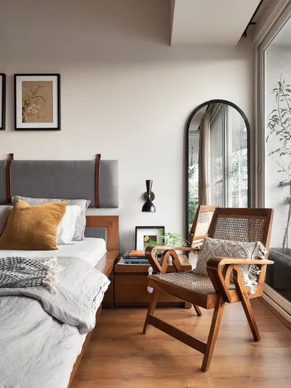 A restored modernist chair sits by the window in the 'Reweave Stories' bedroom. We love incorporating pieces with history, as they add a unique character and story to the space.