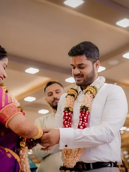 A candid moment during the ring ceremony, capturing the genuine emotions of the couple and their families.