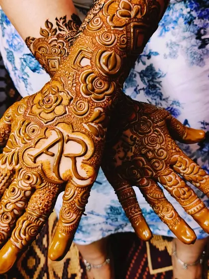 A beautiful shot of Asbah's personalized mehndi, showing how the initials are the focal point of the design.