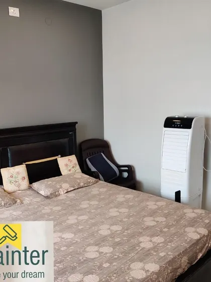 The same bedroom with a grey accent wall, showing how it contrasts with the adjacent white wall for a clean, contemporary look.
