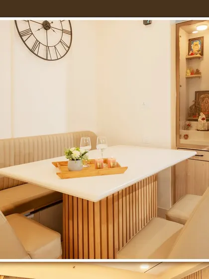 A compact pooja unit integrated next to a dining nook with bench seating, showing how we can incorporate sacred spaces even in smaller apartments.
