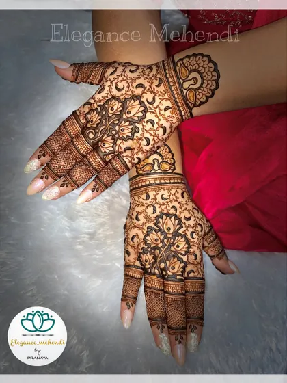 A beautiful backhand design with delicate floral patterns and a peacock motif on the wrist.