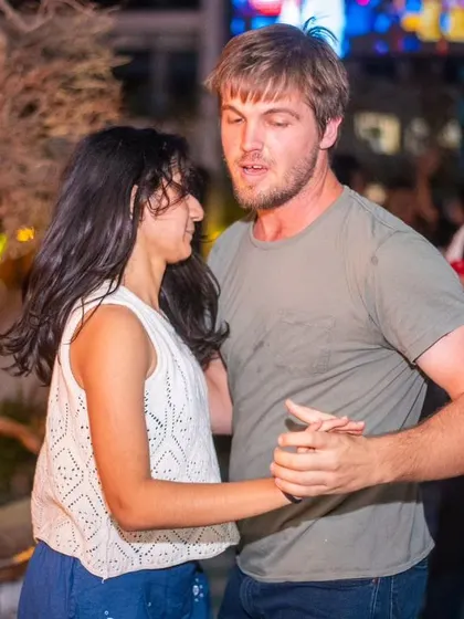 A relaxed and happy dance. The casual outfits show that everyone is welcome as they are.