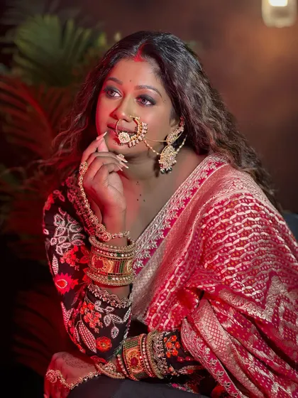 A thoughtful pose. The makeup is designed to look flawless from every angle, enhancing the model's beautiful features.