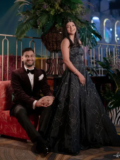 A classic portrait of Tanya and Shivam at their party. Their relaxed smiles and the beautifully decorated venue create an image of effortless elegance and happiness.