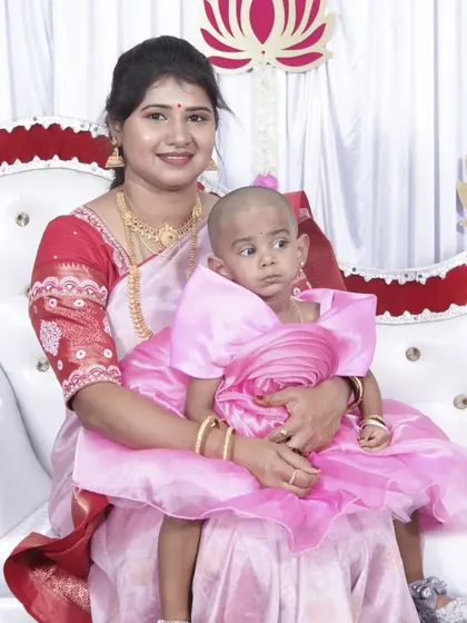 A mother and her child at a baby-related function. The mother's makeup is simple and elegant, perfect for a family-focused celebration.