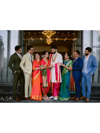 A beautiful family portrait with the couple and their parents, a cherished memory from the engagement day.