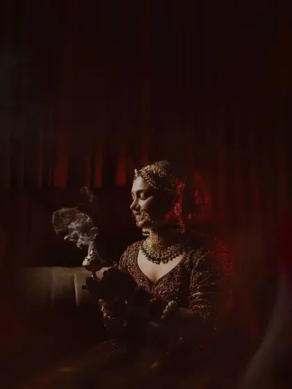 An artistic shot of the bride during a ritual, with smoke creating a beautiful, ethereal effect.