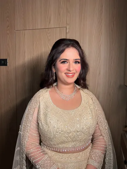 A smiling shot of this client, her makeup looking fresh and radiant for the party.