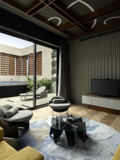 The entertainment area on the third floor of The House of Dancing Screens opens directly onto the pool terrace. This seamless connection creates a fluid, versatile space for family activities and social gatherings.