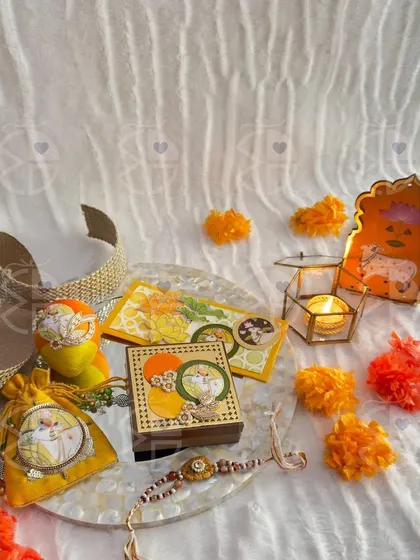 A flat-lay of one of my Rakhi gift sets. This arrangement on a mother-of-pearl tray includes a 'rakhi', a candle, and other small, beautifully coordinated items.