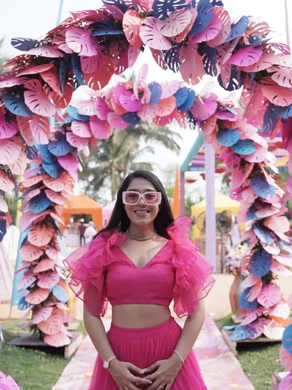 Another look at this gorgeous pink outfit, this time with funky pink glasses to match the playful vibe of the event decor.