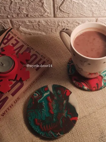A cozy Christmas scene featuring our marbled coasters and a Snowflake T-light holder. We designed these coasters with a festive red and green marble effect, perfect for your cup of hot chocolate.