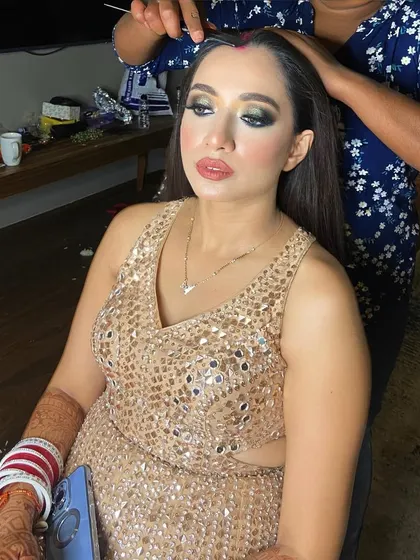 Final touches on the hair for this reception look. I ensure every strand is in place to complement the stunning green smokey eye and the sequined gown.