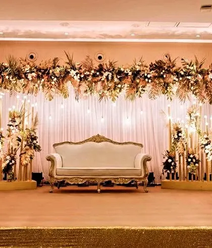 The perfect stage for a Sangeet or engagement. The royal hues of peach, green, and off-white, combined with elegant lighting, create a sophisticated and warm ambiance.