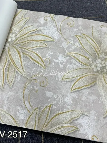 A wallpaper sample with a large, stylized floral pattern in gold and white on a grey textured background.