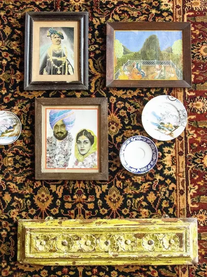 Another view of our curated wall art, where portraits of Indian royalty are mixed with decorative plates, creating a harmonious celebration of human creativity.