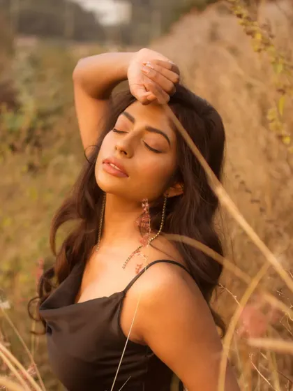 A close-up portrait with eyes closed, capturing a serene and peaceful moment. The warm golden light enhances the tranquil mood of this beautiful lifestyle shot.