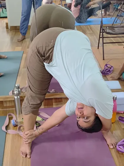 A student in a deep forward fold, Prasarita Padottanasana, during one of our workshops.
