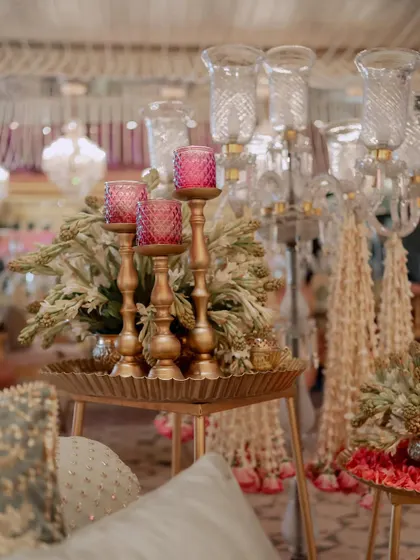A close-up of the side table decor, showing how we layer different elements like floral arrangements, candles, and brass trays to create visually interesting compositions.