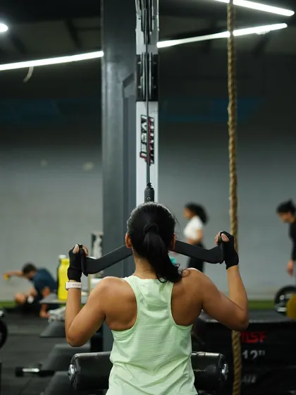 Developing a strong back with lat pulldowns. This exercise is key for improving posture and building that V-taper physique.
