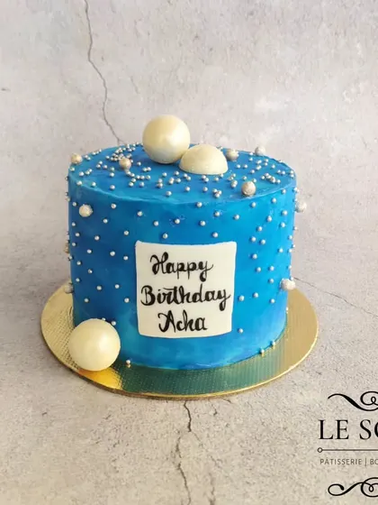 A simple and elegant cake for Acha's (Dad's) birthday. This half-kg Vanilla Caramel cake is a beautiful shade of blue, decorated with white chocolate spheres and sprinkles.
