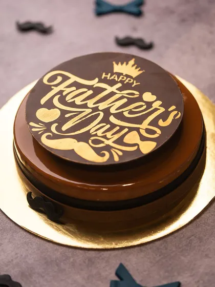 A special cake designed just for Father's Day. This coffee and chocolate creation has a rich, glossy finish and is topped with a custom "Happy Father's Day" chocolate plaque.