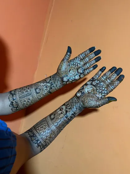 A side view of a full bridal mehendi, showing how the design wraps around the arm for a complete and beautiful look.