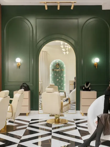 The main styling area of the Gauri Kakas makeup studio, where bold black-and-white Italian tiles meet deep green walls with neoclassical wainscoting, creating a sense of grandeur and modern luxury.