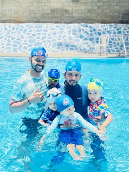 Our pool is a community. Here, a group of our young swimmers and coaches celebrate a great session together, showcasing the supportive and friendly atmosphere we foster at the academy.