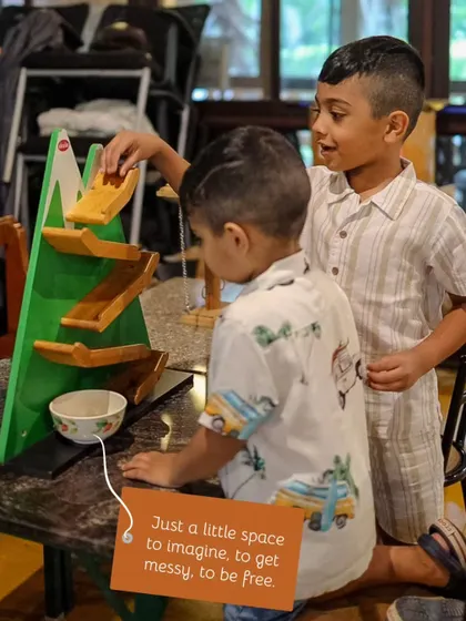 Children explore one of our wooden educational toys, designed to spark imagination and playful learning.