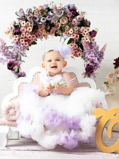 A wide shot of the lavender floral first birthday setup, complete with a "One" sign. I customize each birthday set to match your vision and color scheme.