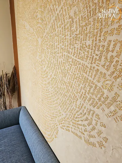 For this villa entrance, we created a modern spiritual ambiance. A custom wall with engraved Hindu shlokas in gold provides a stunning backdrop for a bold blue sofa, blending tradition with contemporary design.