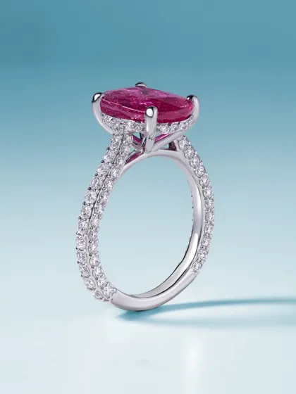 A side view of the passion-fueled ruby ring. This angle shows the delicate double-pavé band and the gallery that holds the magnificent gemstone, highlighting the intricate craftsmanship that goes into every piece.