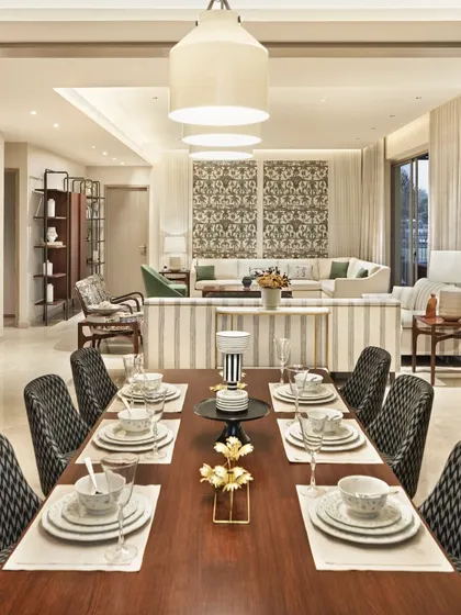 A long shot of the dining and living area in the Max128 apartment, showing the open, flowing layout and cohesive design.