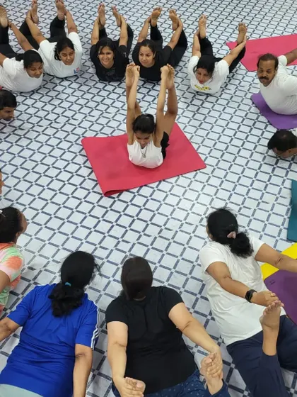 Another creative formation from our Yoga Day celebration. This pose requires flexibility and coordination from the entire group.