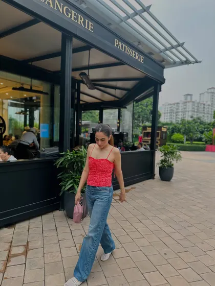 A walking shot, showing the movement of the wide-leg jeans.