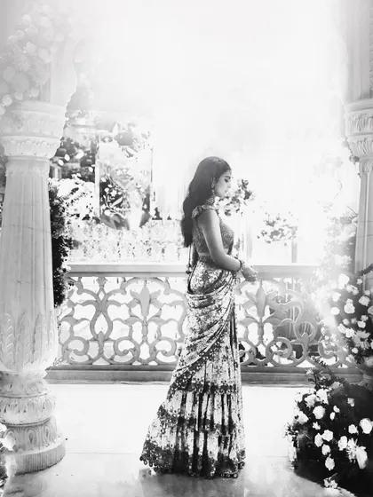A beautiful black and white shot that captures the timeless elegance of the Arpita Mehta saree. The play of light and shadow highlights the silhouette and intricate details.