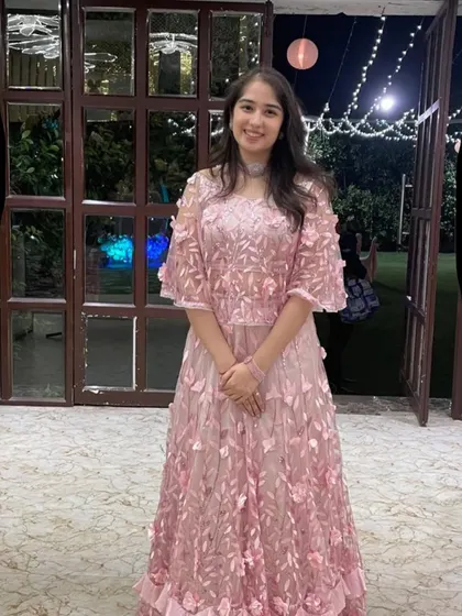 A close-up of the 3D floral embroidery on this pink Indo-western cape and skirt set. It's these little details that make an outfit truly special and unique.