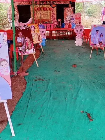 A gallery of the couple's photos displayed on easels along the entrance path of their baby shower.