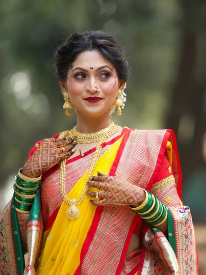 A confident and glamorous pose. The bold lip color and defined eye makeup create a striking look that is both traditional and modern.