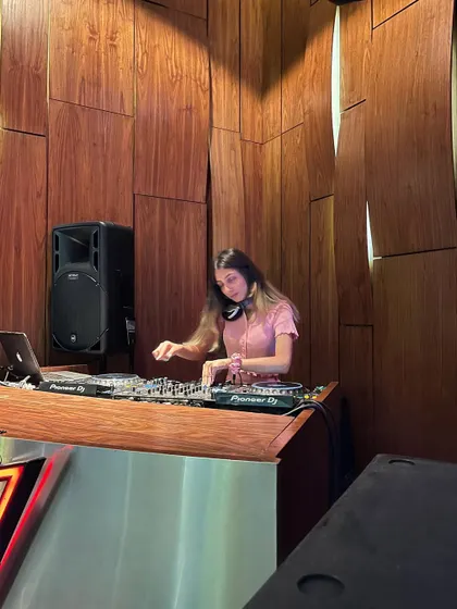 In the zone at the stylish, wood-paneled DJ booth at Taj Gurugram. The venue's ambiance is a key part of the experience.
