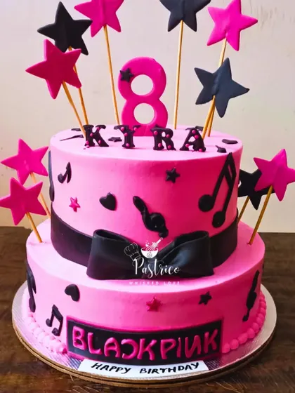A K-Pop fan's dream! This two-tiered Blackpink themed cake is decorated with stars and musical notes in the band's signature colours.