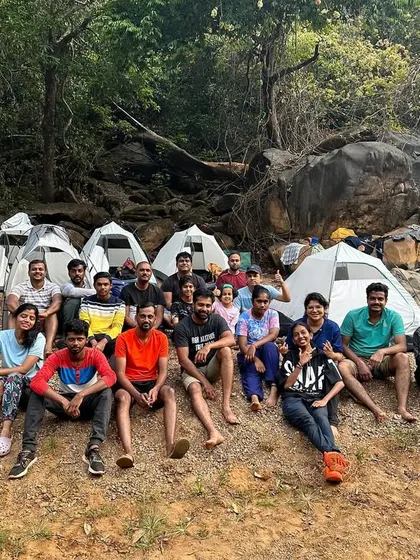 A group photo with our tents pitched by the river. This is what riverside camping looks like.
